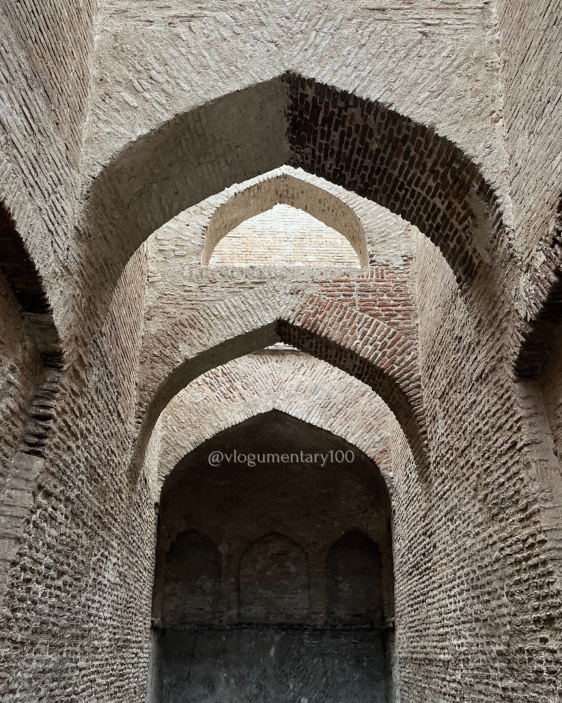 Interior view of the Wan Bhachran Stepwell, showcasing pointed arches and small bricks that highlight the architectural beauty celebrated in heritage tourism in Pakistan

