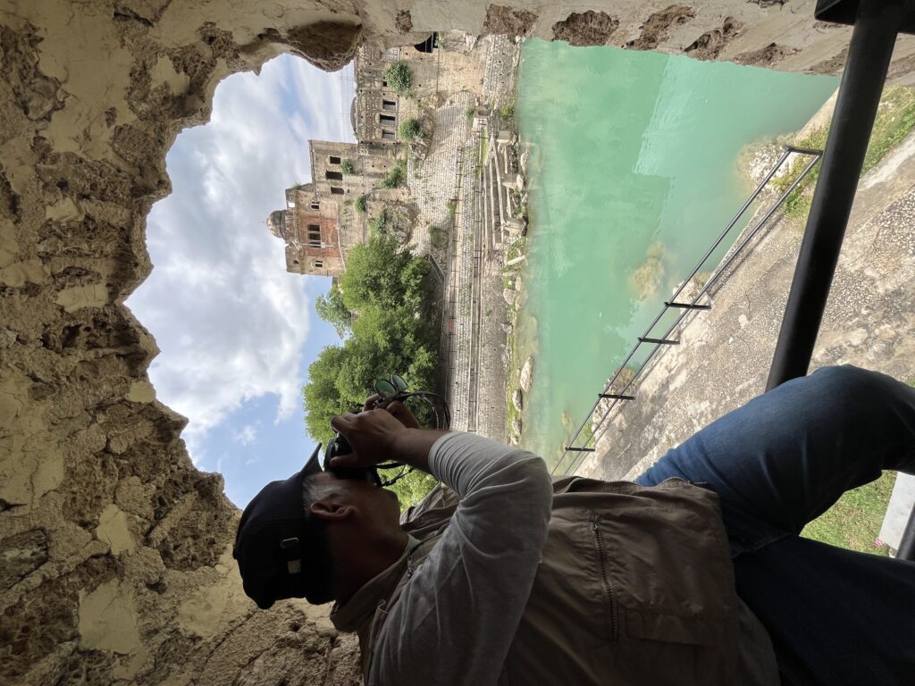 Dr. Mohammad Amir capturing the serene beauty of the Katas Raj sacred pond through his lens