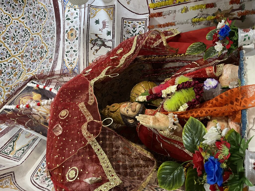 An idol of Hanuman Ji resting inside an active temple within the Katas Raj complex
