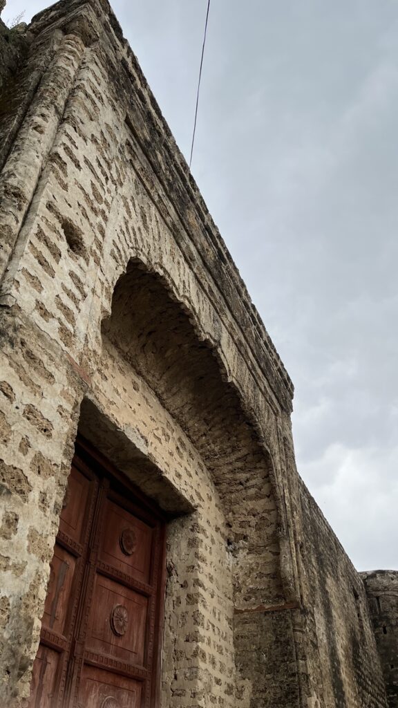 The entrance door of the Hari Singh Nalwa Haveli, marked by historic wooden craftsmanship