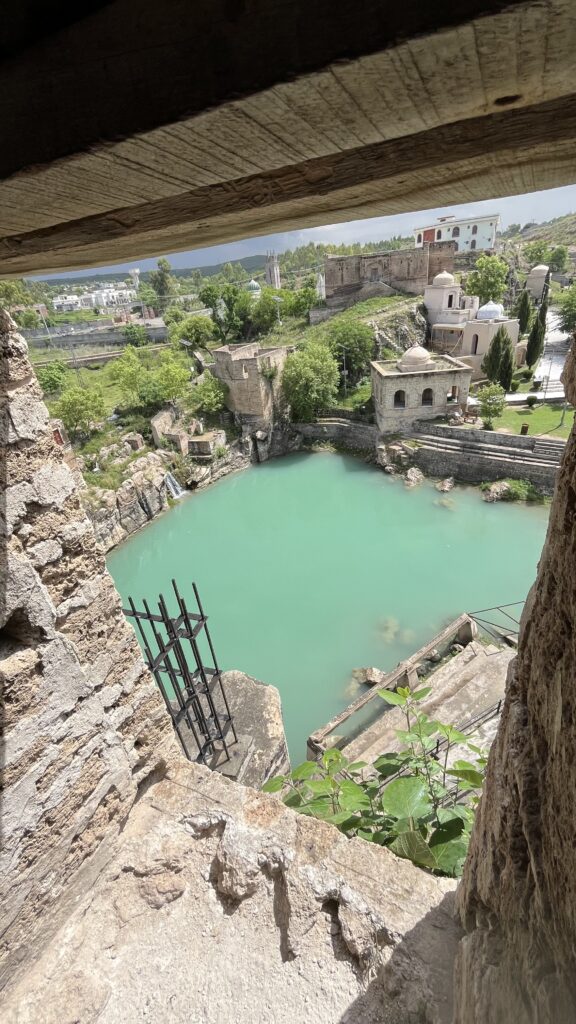 A high-angle aerial view of the sacred pond of Katas Raj, taken from a nearby tall building