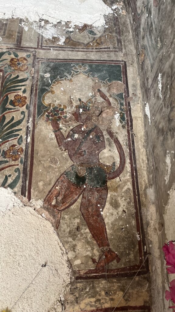 A fresco painting of Hanuman Ji adorning the wall of a Katas Raj temple, preserving vibrant artistry from the past