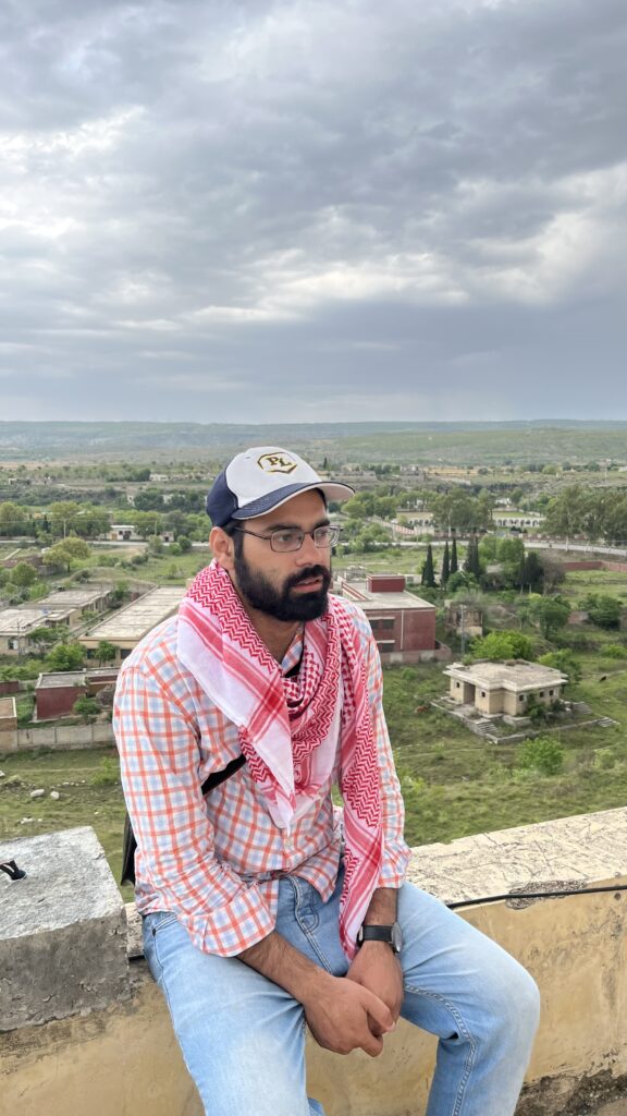 A rooftop view from the katas raj temple, with a glimpse of surrounding greenery fading into the horizon