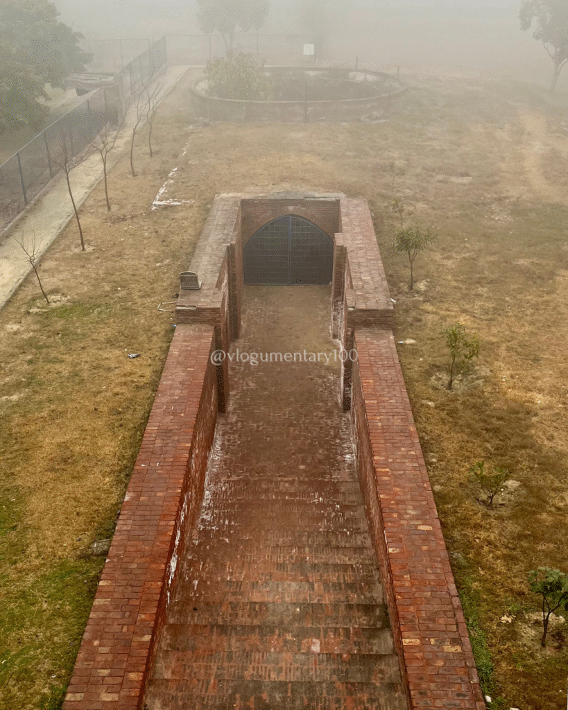 A photo taken from the roof of the baoli, in which some stairs can be clearly seen, while the path ahead is blocked by a door.