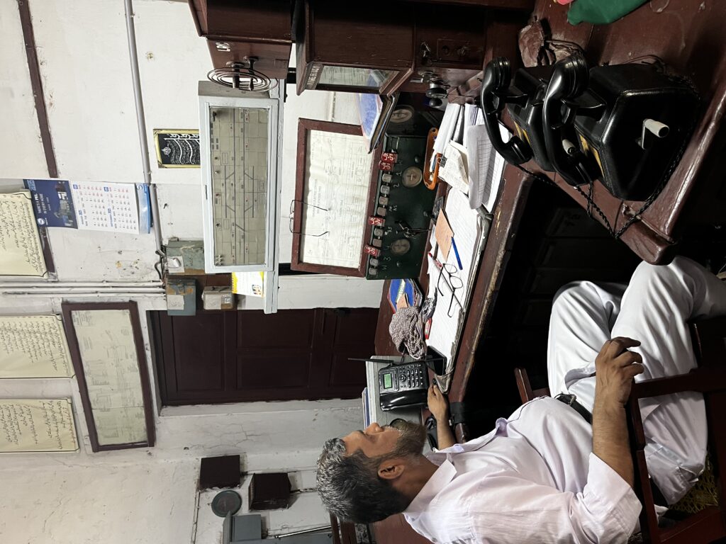 Station master showing vintage railway equipment at Walton Station